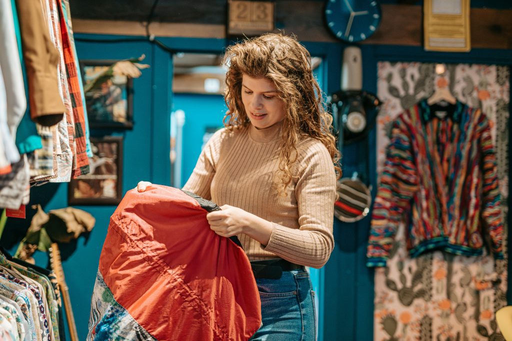 Second hand Hamburg: a girl picking a vintage find in a store