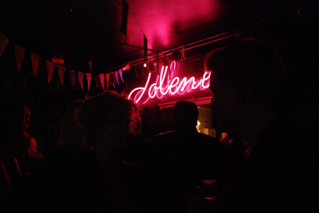 Nightlife in Denmark Copenhagen: Jolene club written on a neon and the crowd