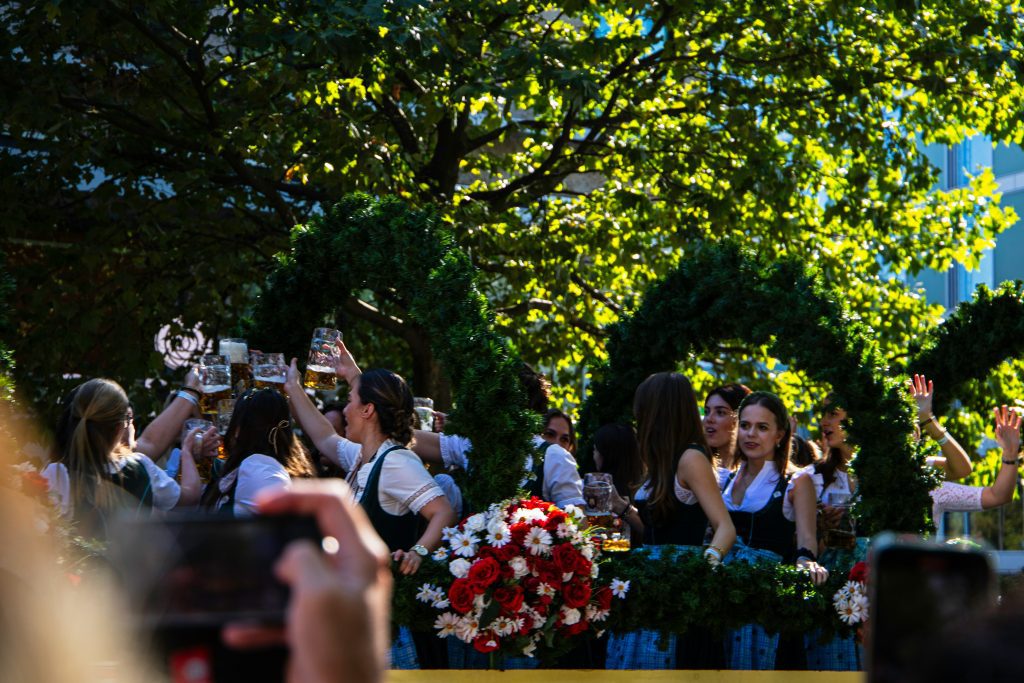 Facts about Munich: girl in traditional Bavarian clothing cheering and dancing outside