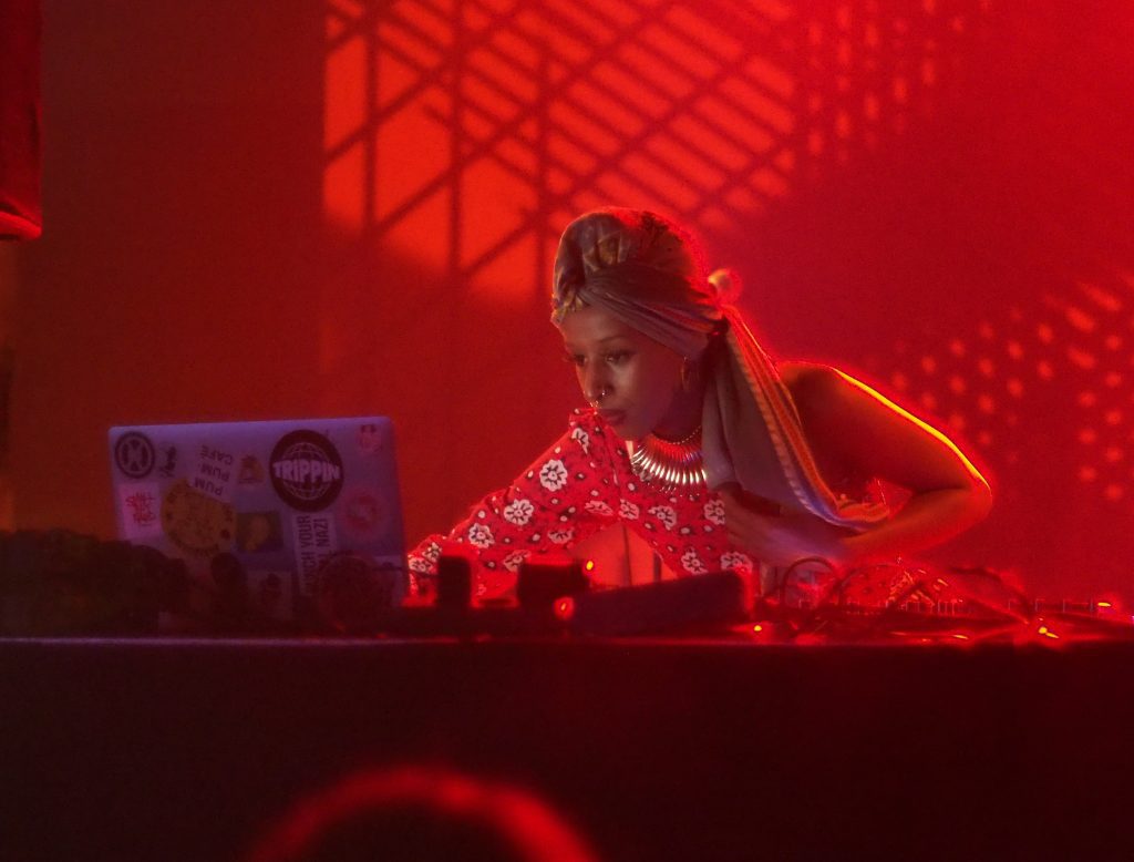 Cool bars in Berlin: a female dj looking at the computer screen during her set