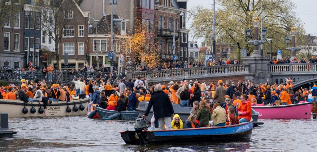 King's day Netherlands: boats on the canal celebrating King's day