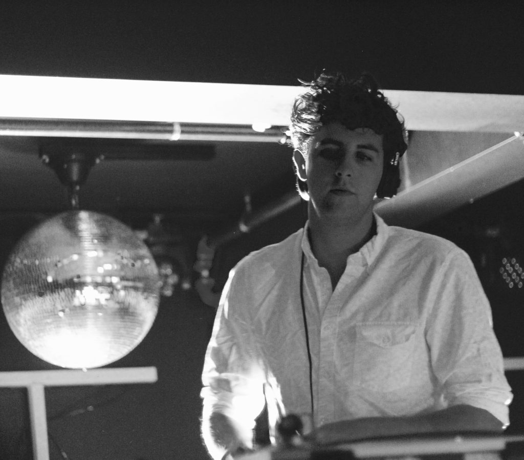 Concerts in Paris: Jamie XX performing at a nightclub with a disco ball in the background