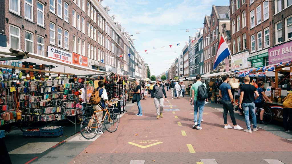 Bank holiday the Netherlands: shoppers browsing stalls at open-air market in Amsterdam, Holland.